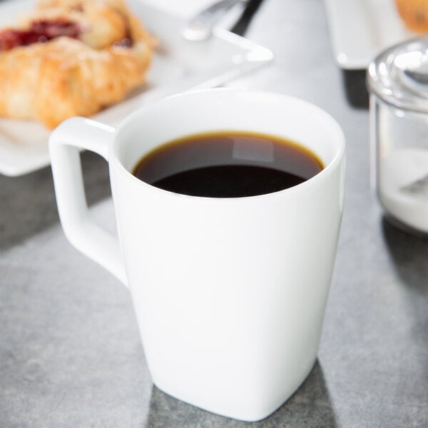 A white porcelain mug filled with black coffee.