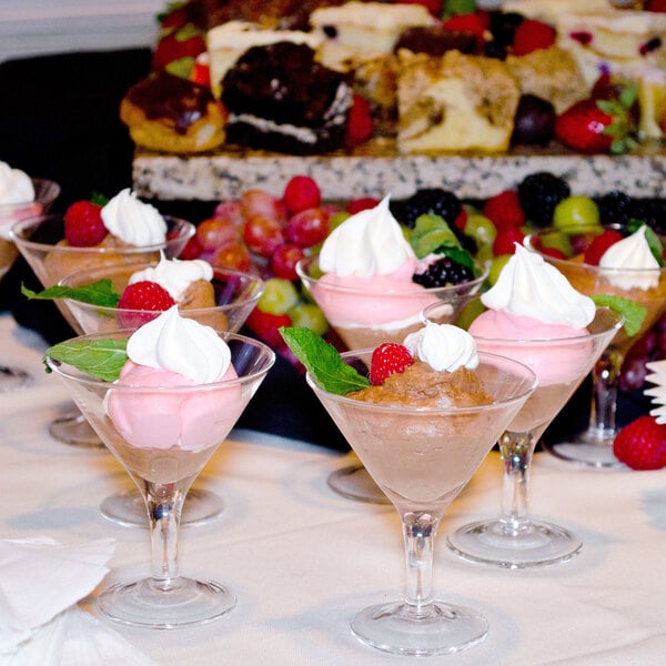 A group of Libbey Mini Martini Glasses with assorted desserts on a table.