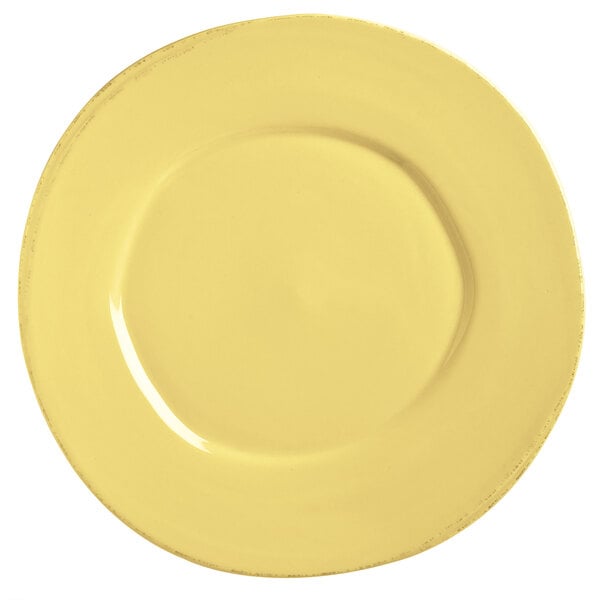 A close up of a Libbey Farmhouse yellow porcelain plate with a rim.