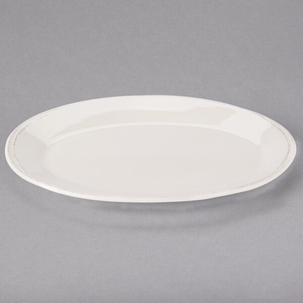 A white Libbey oval porcelain platter with a rim.