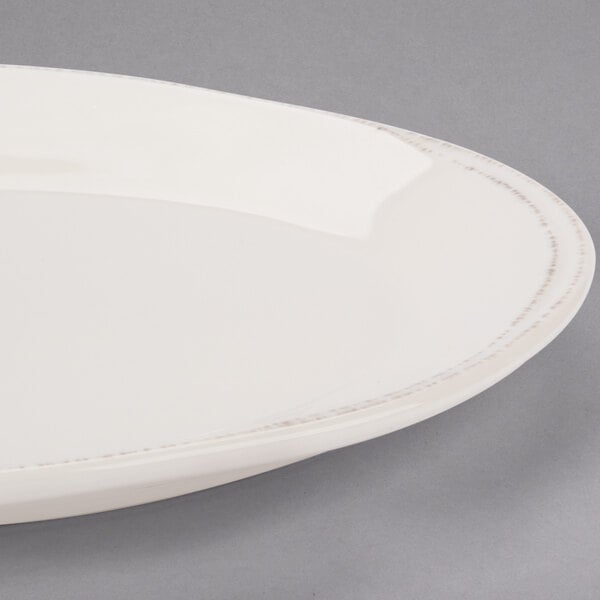 A white Libbey oval porcelain platter with a rim.