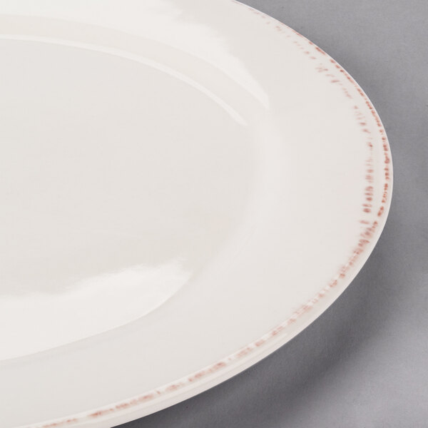 A white Libbey porcelain plate with a brown rim.