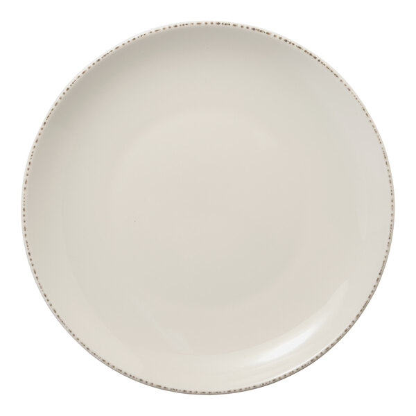 A white Libbey Farmhouse Coupe porcelain plate with a brown speckled rim.