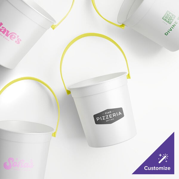 A close-up of a white Howw Manufacturing plastic bucket with yellow handles.