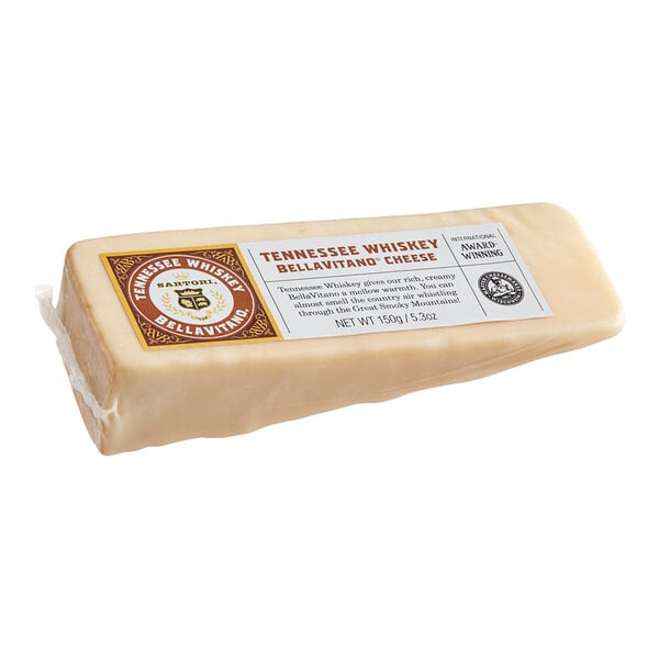 A wedge of Sartori Tennessee Whiskey BellaVitano cheese with a label on it.