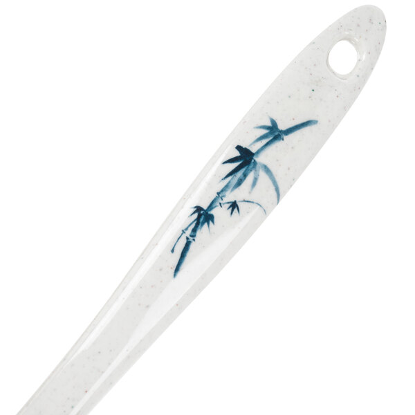 A white Thunder Group spatula with a blue bamboo design on it.
