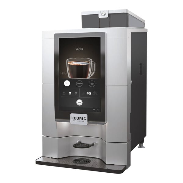 A Keurig Eccellenza Momentum single cup coffee maker with a screen on it brewing coffee into a glass cup.