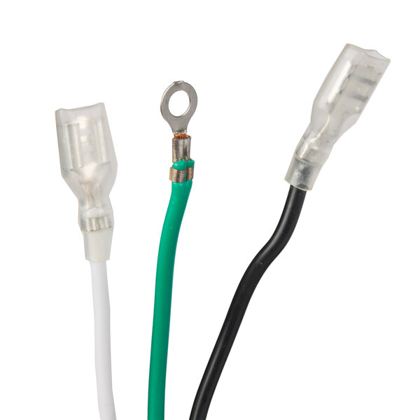 A close-up of two electrical wires with green and white connectors.