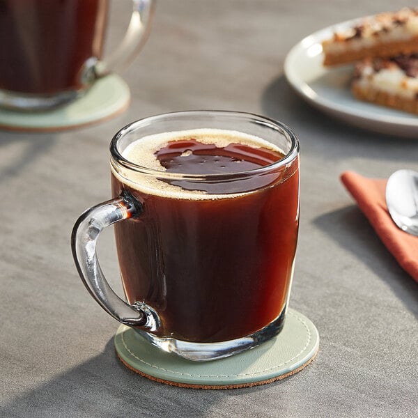 A glass mug of Maxwell House Original Roast coffee on a coaster.