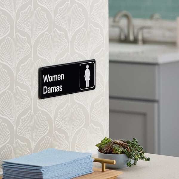 A Lavex women's restroom sign with a black and white design.