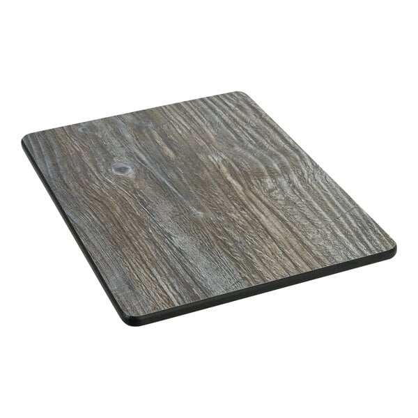 A BFM Seating driftwood composite rectangular table top sample with a wood grain finish.