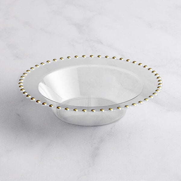 A clear plastic bowl with gold beaded trim.