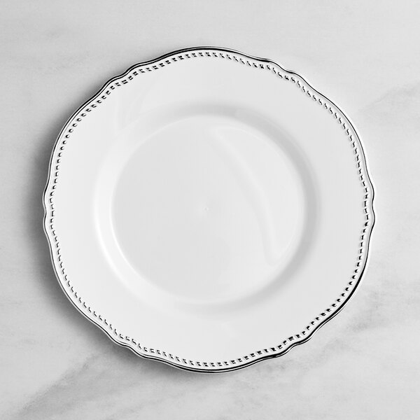 A Visions white plastic plate with a silver rim.