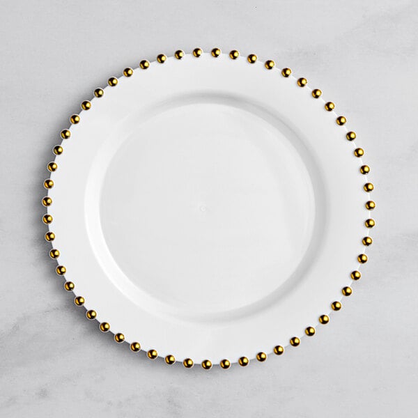 A white Visions plastic plate with a gold beaded rim.