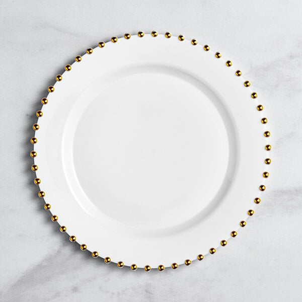 A white Visions plastic plate with a gold beaded rim.