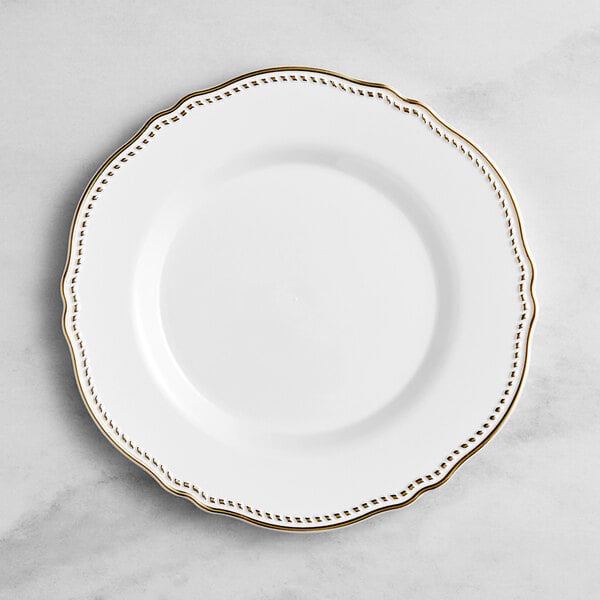 A Visions white plastic plate with gold vintage trim.