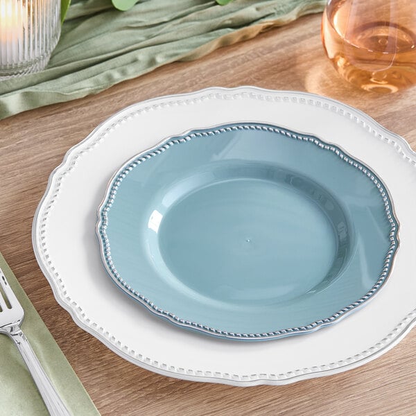 A Visions steel blue plastic plate with a silver vintage rim on a table.