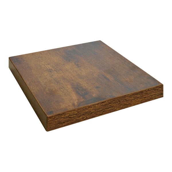 A BFM Seating Relic vintage walnut square melamine table top with matching edge on a table.