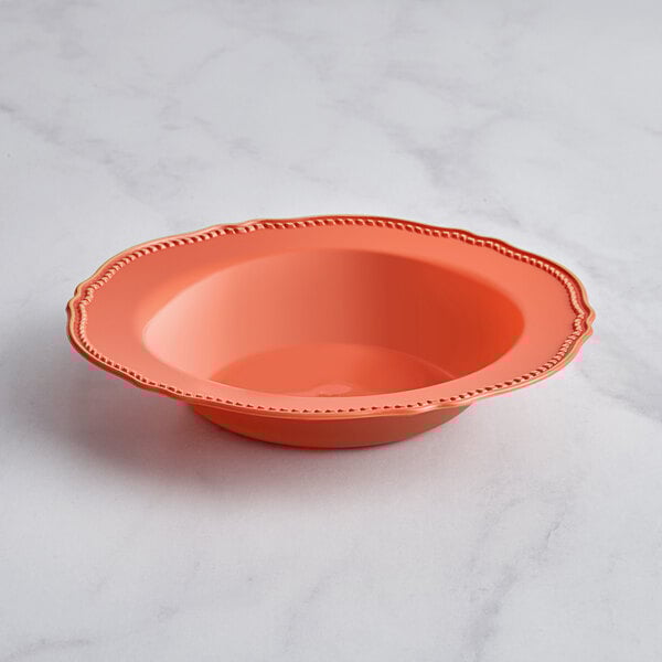 A Visions terra cotta plastic bowl with a gold beaded border.