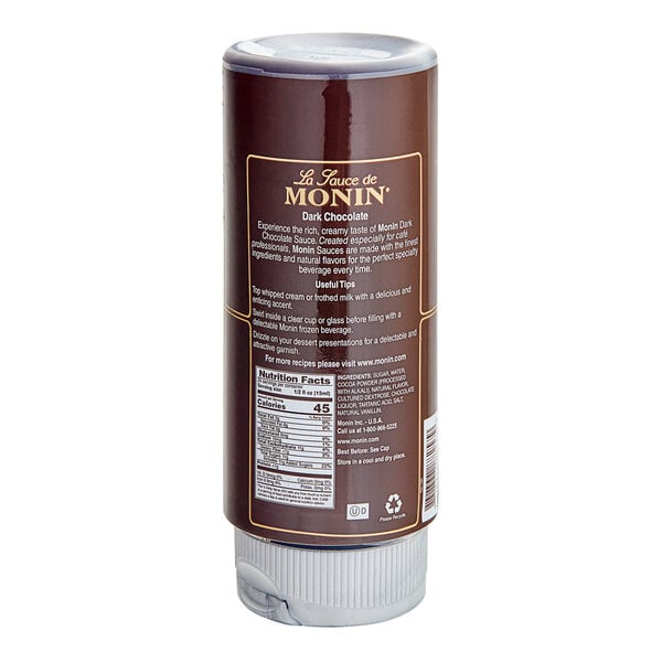 A brown Monin bottle of dark chocolate flavoring sauce with a label.