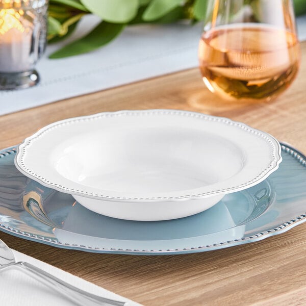 A white plastic bowl with a silver vintage rim on a table.