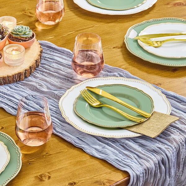 A table set with Visions Eucalyptus plastic plates and glasses.