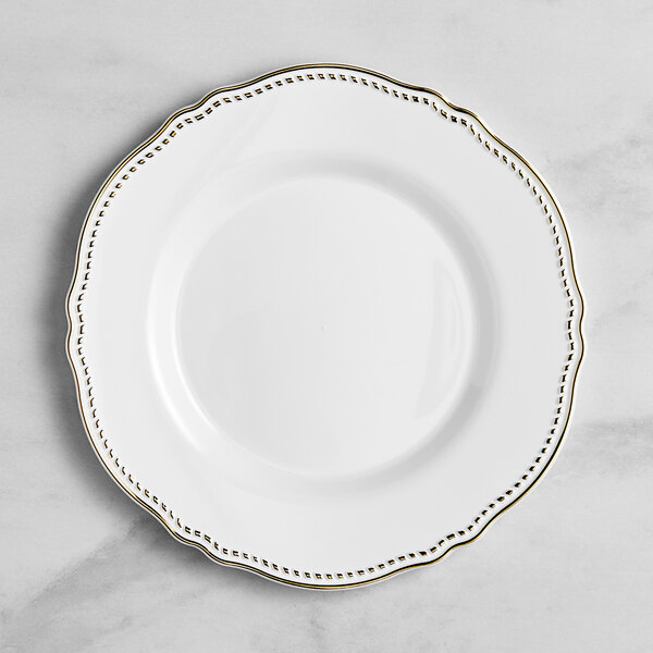 A Visions white plastic plate with gold vintage trim.