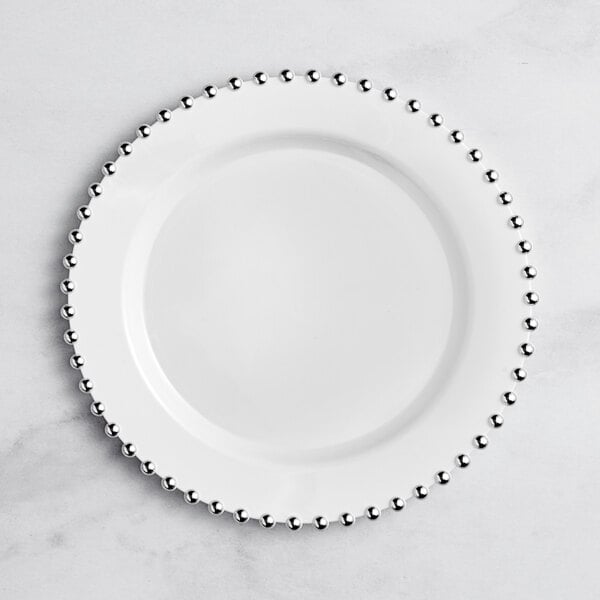 A white Visions plastic plate with silver beaded rims.