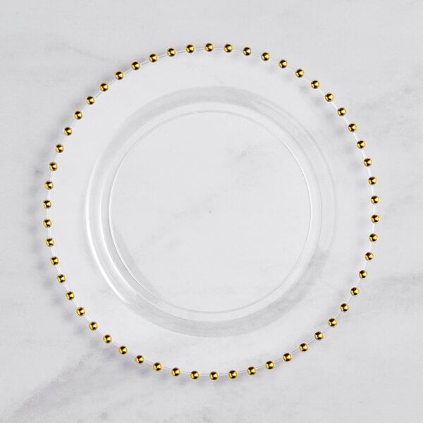 A clear plastic plate with gold beading on the rim.