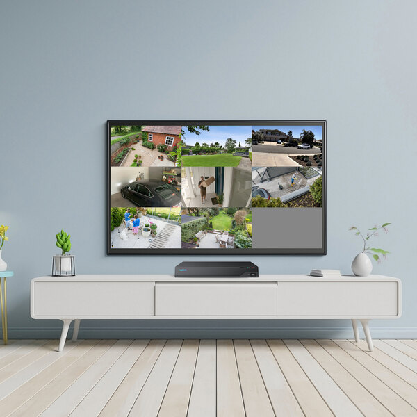 A television with a large screen showing a house with a white wall and black panel.