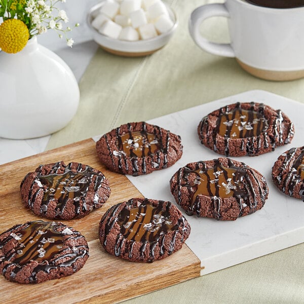 A chocolate cookie with Monin Sugar-Free Dark Chocolate Sauce on top.