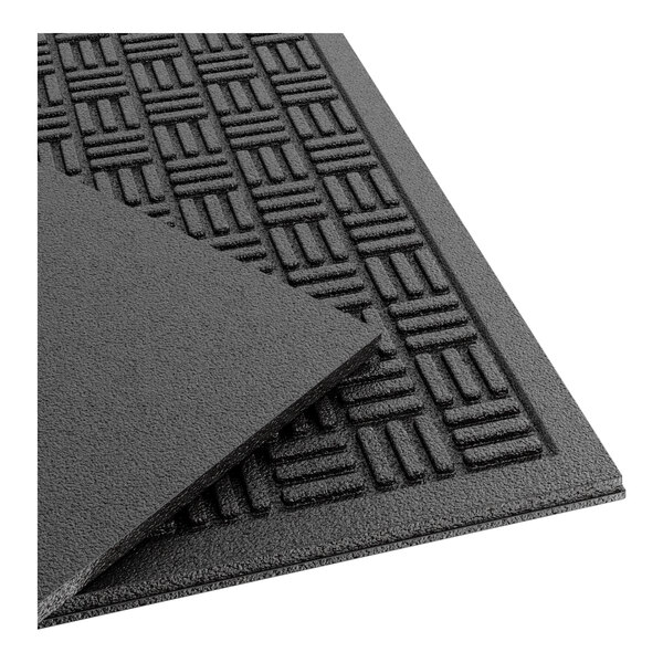 A close-up of a black Lavex parquet entrance mat with a pattern on it.