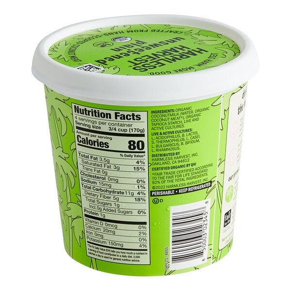 A green container of Harmless Harvest plain unsweetened dairy-free yogurt alternative with a white lid.