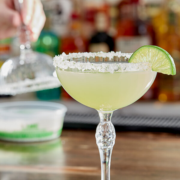 A glass with a margarita with Twang Lime Rimming Salt on the rim.