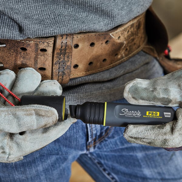 A person holding a Sharpie Pro Chisel Tip Permanent Marker.
