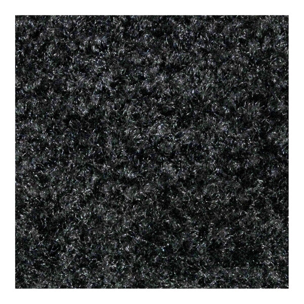 A close-up of a black M+A Matting carpet with a rubber border.