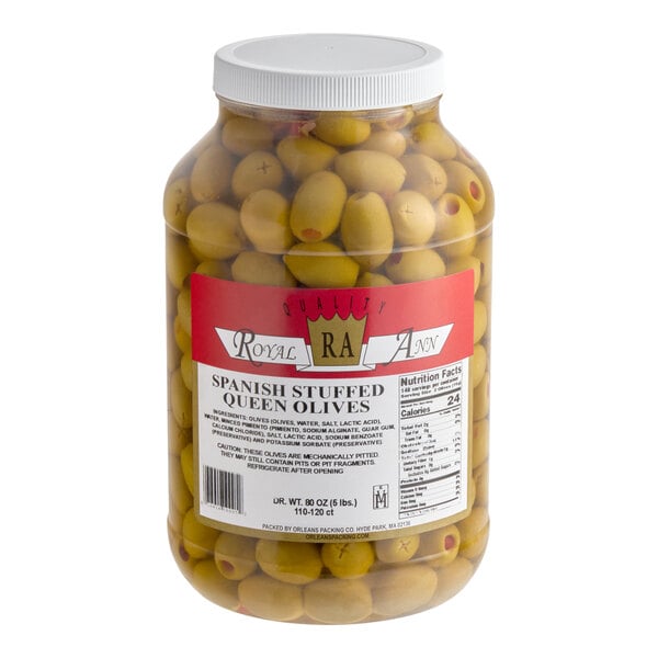 A large plastic jar filled with Spanish stuffed queen olives.
