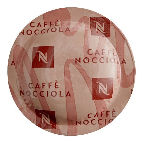 A Nespresso Professional Caffe Nocciola single serve coffee capsule on a plate.