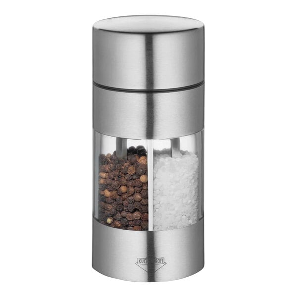 A Kuchenprofi stainless steel salt and pepper mill with black peppercorns.