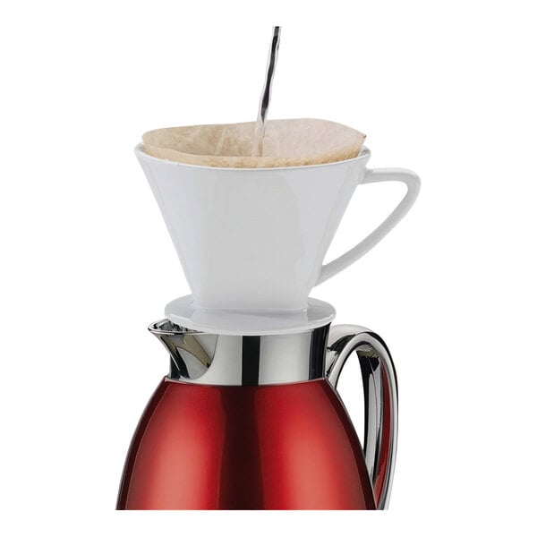 A Cilio stainless steel coffee carafe with a white cup and filter.