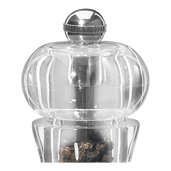 A clear acrylic salt and pepper mill set on a counter.