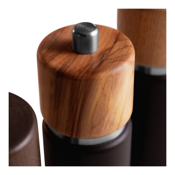 A close-up of a Zassenhaus Hannover olive wood and metal pepper mill.