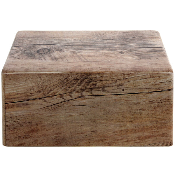 A rectangular faux driftwood melamine display riser.