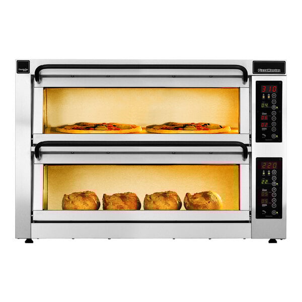 A PizzaMaster electric double countertop pizza oven with two trays of food inside.
