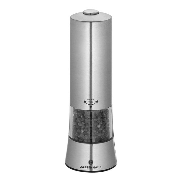 A silver and black Zassenhaus Gera electric stainless steel pepper mill grinding black peppercorns.