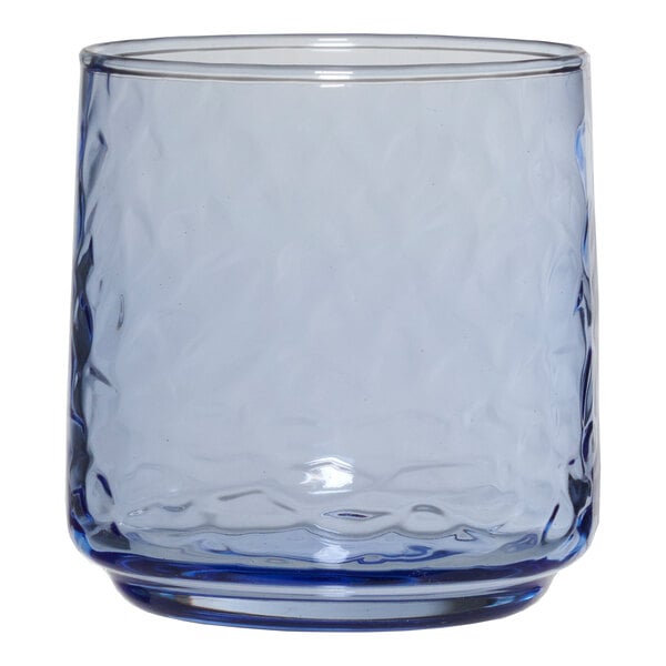 A clear glass Anchor Hocking Brockhill Coastal Blue rocks glass with a blue rim.