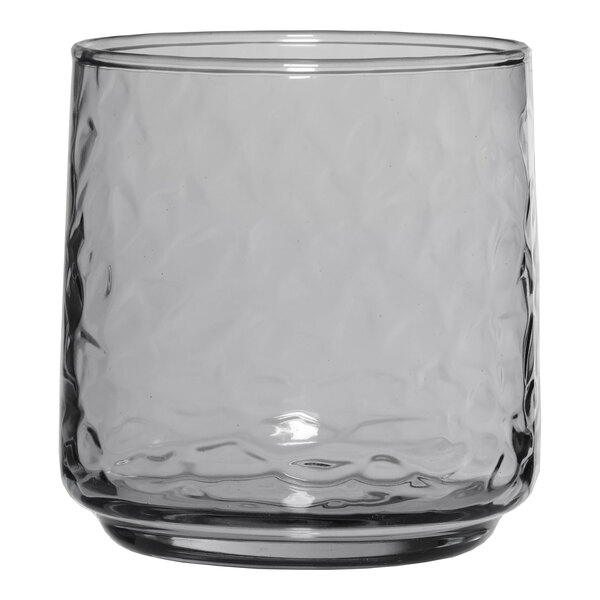 A smoke gray Anchor Hocking Brockhill rocks glass with a textured pattern.