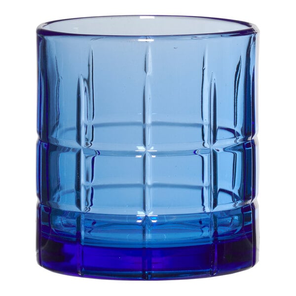 A blue Anchor Hocking rocks glass with a checkered design.