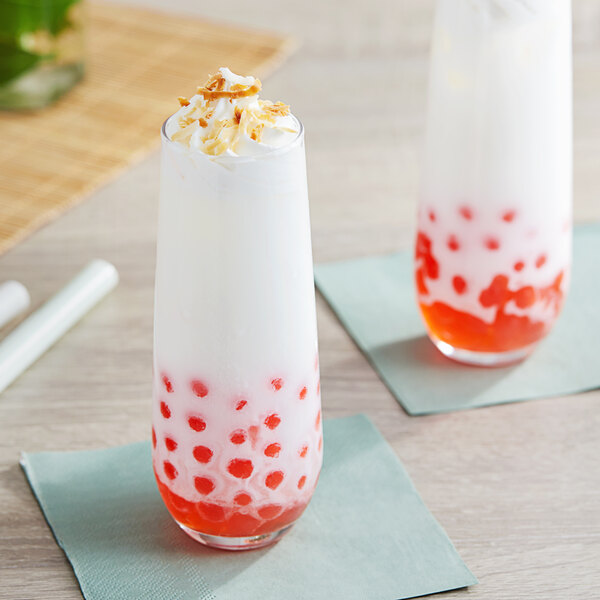 A glass of milkshake made with Possmei Coconut Powder mix with red and white toppings.