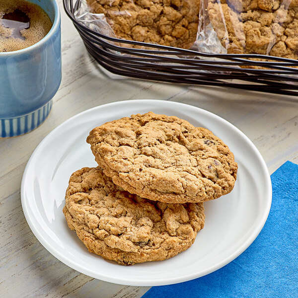 A plate with a stack of Southern Roots individually wrapped oatmeal raisin cookies on a table.